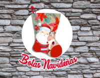 Christmas trees in the foreground in artificial snow and a blurred background with a glowing garland